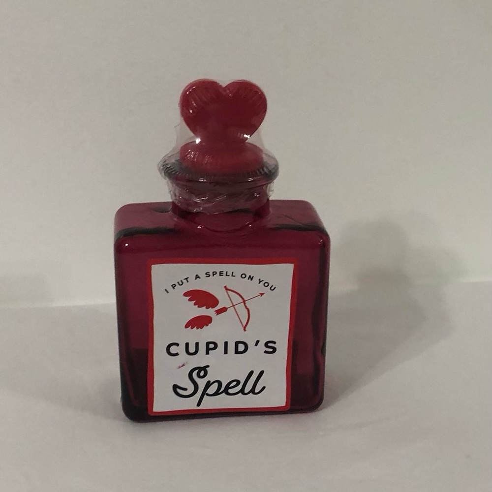 Glass bottle with heart silicon lid.Size 4”H X 3”W. pink red